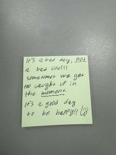 Handwritten sticky note with words of encouragement